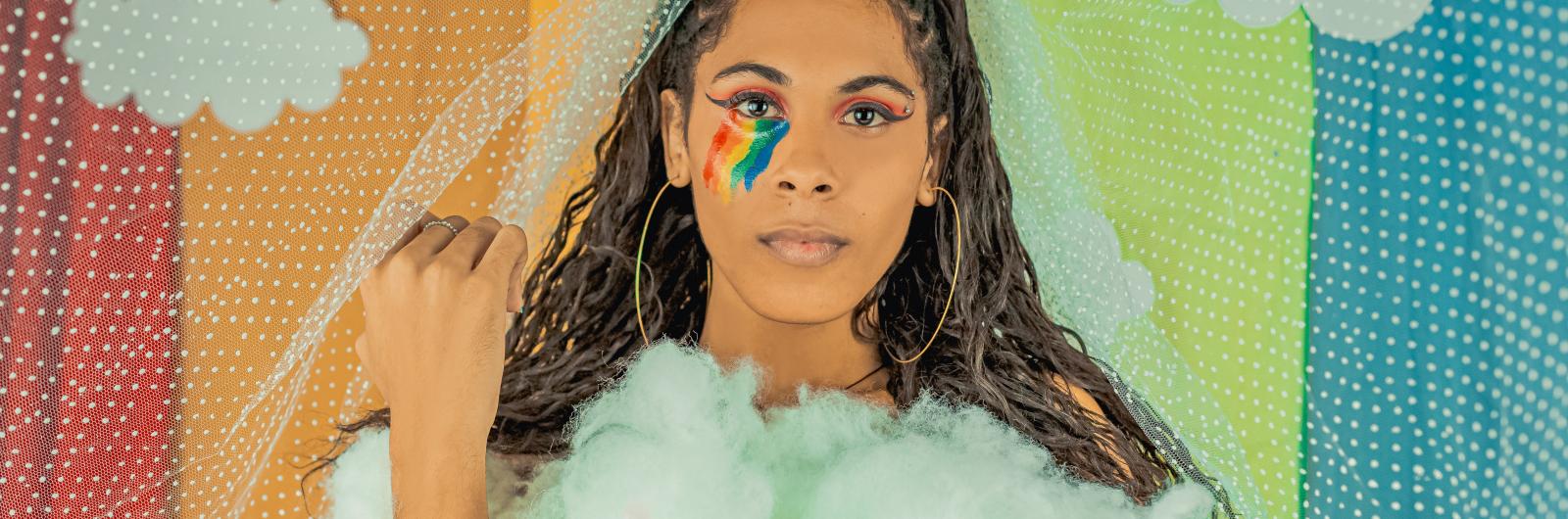 Transgender woman with a rainbow background